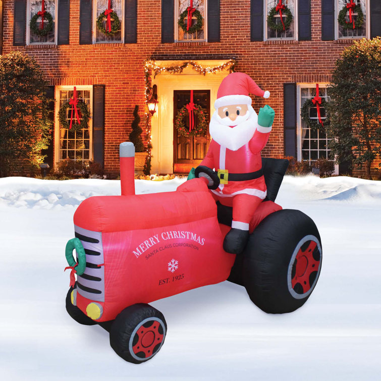 The Holiday Aisle® Santa on Tractor Inflatable Wayfair